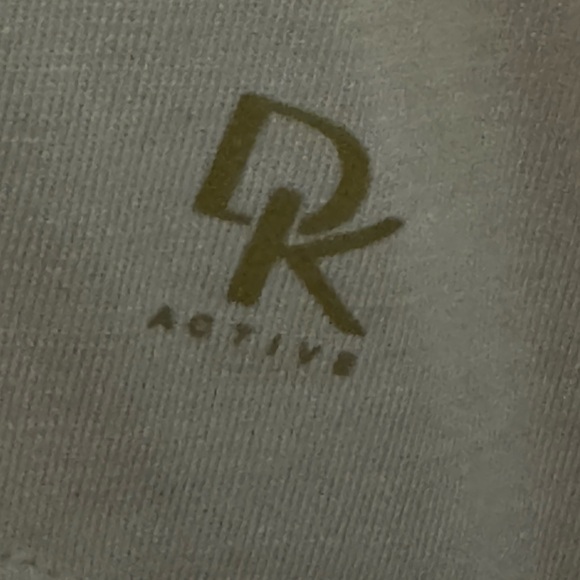 Short sleeve shirt with cut out shoulders shirt is a peachy pink color - Picture 3 of 4